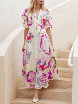 Midi dress with abstract print, puff sleeves, button front, and V-neck.