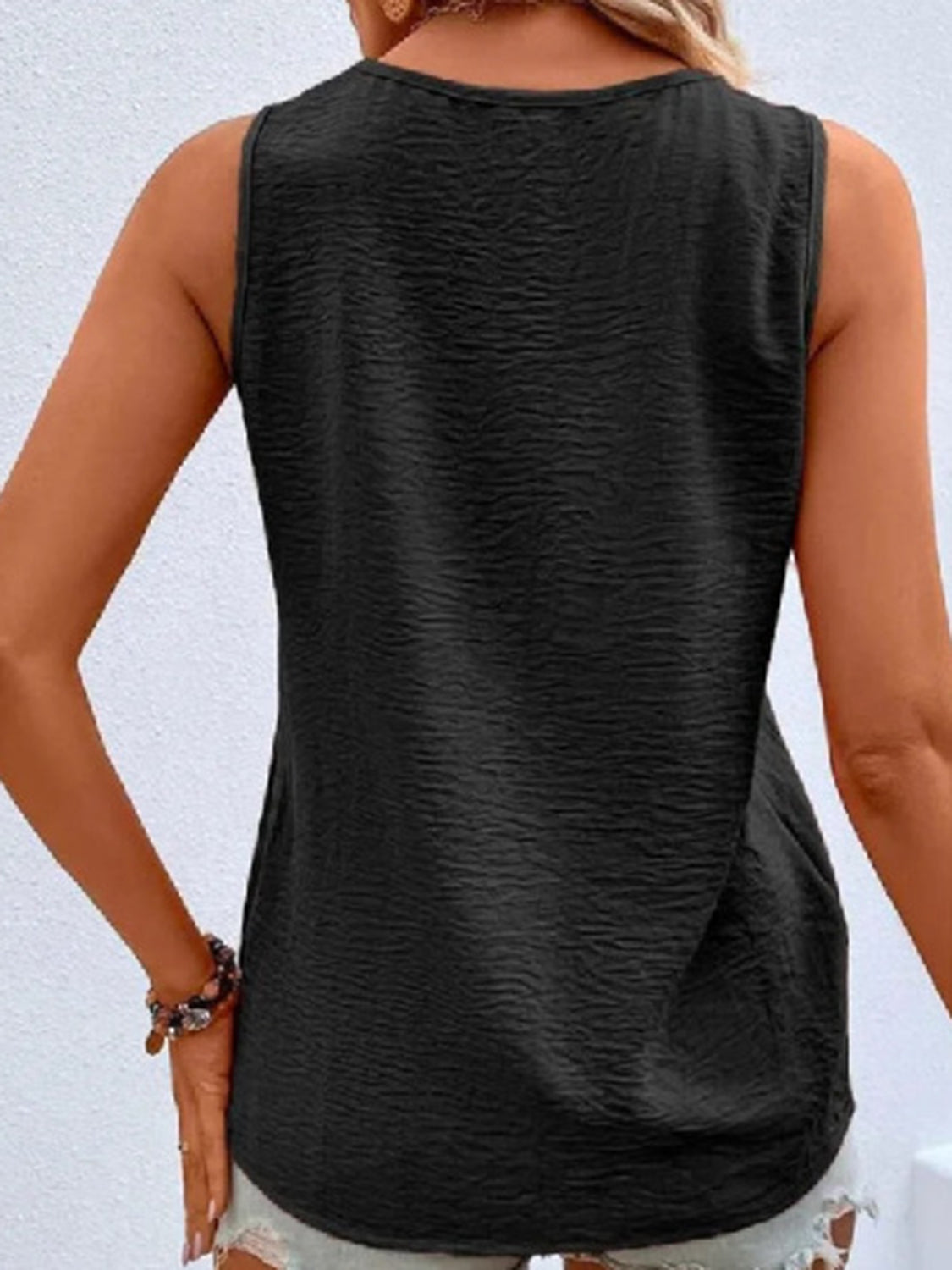 Black textured sleeveless V-neck top with button front detail
