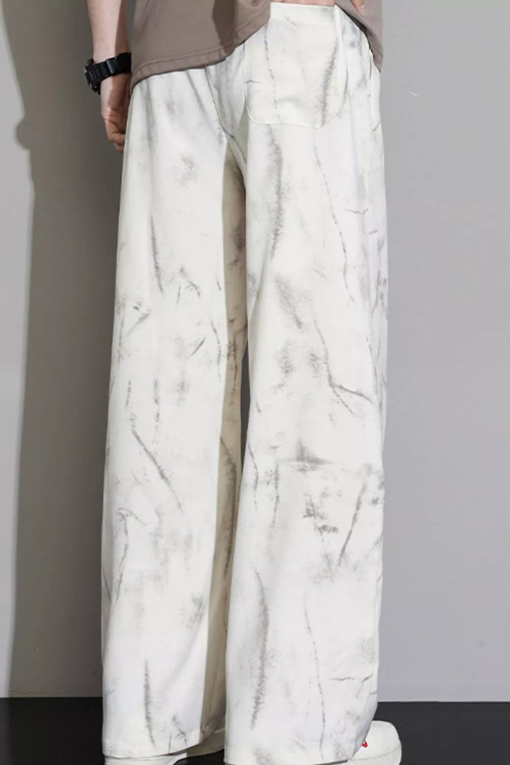 Men's white sweatpants with marbled grey pattern and drawstring waist.