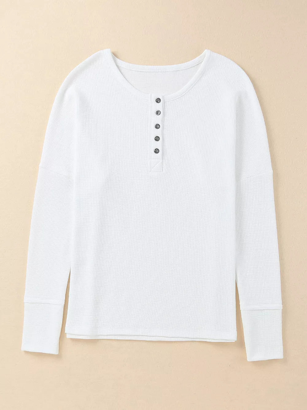 White textured cotton henley shirt with button placket and long sleeves.