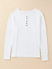 White textured cotton henley shirt with button placket and long sleeves.
