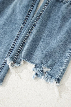 Distressed denim flare jeans with raw, frayed hems and open knee details.