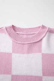 Checkerboard knit crewneck sweater in Dusty Pink and white acrylic with ribbed neckline.