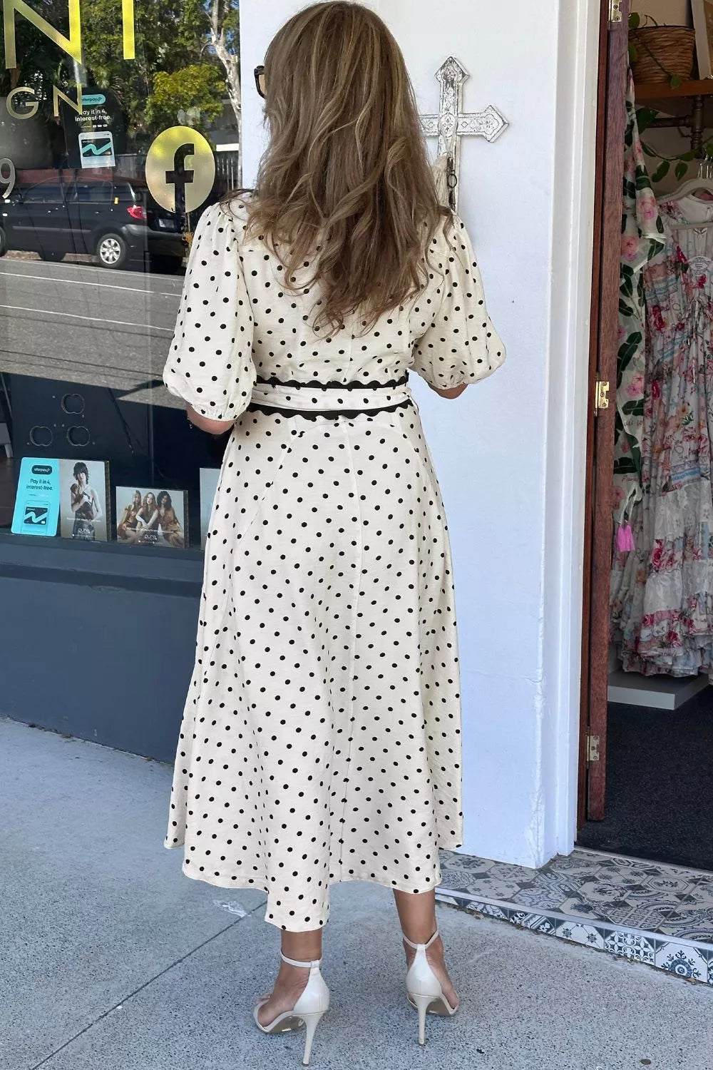 Cream polka dot midi dress with tie belt and puff sleeves.