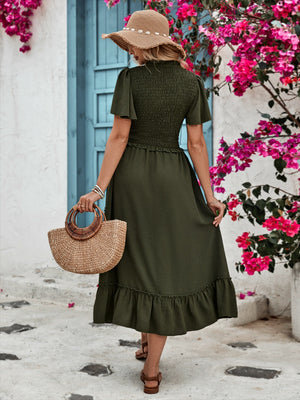 Dark green tiered midi skirt with smocked bodice and ruffled hem.