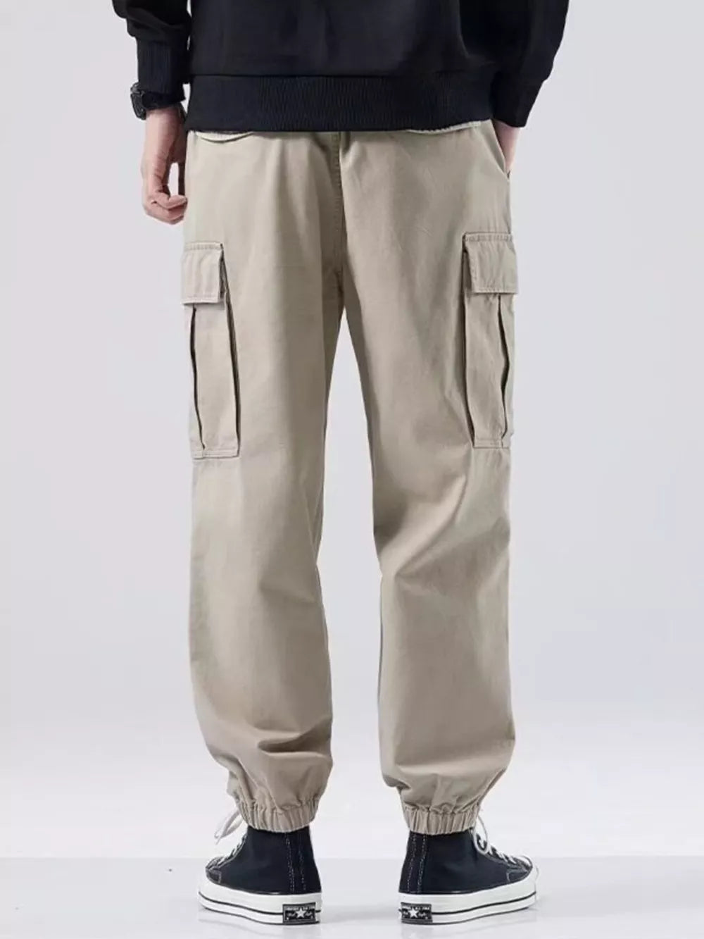Khaki relaxed fit cargo sweatpants with elastic cuffs and side pockets.