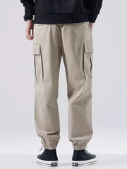 Khaki relaxed fit cargo sweatpants with elastic cuffs and side pockets.
