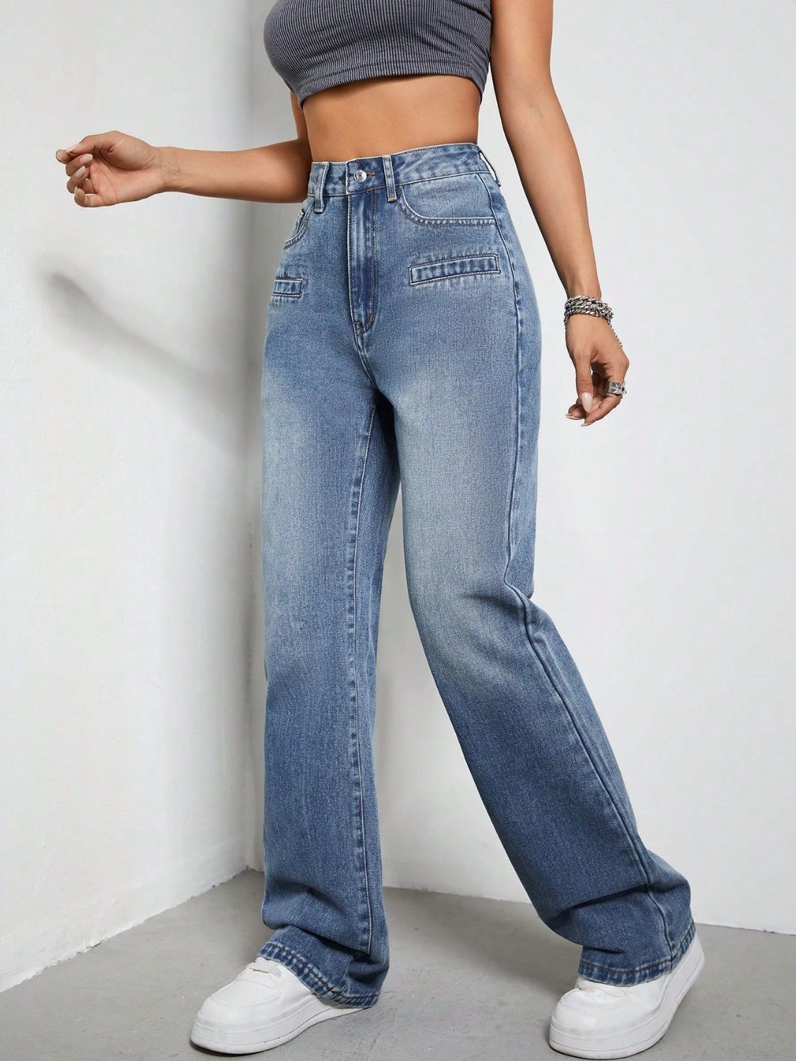 Medium wash cotton wide-leg jeans with utility pockets and a high waist.