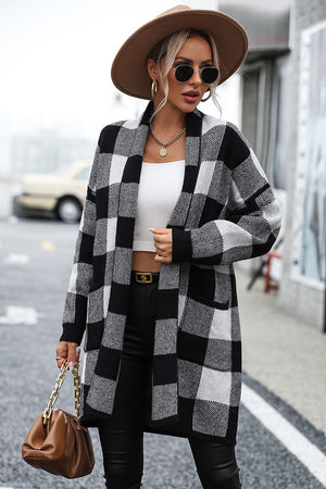 Black and white checkerboard knit duster coat with open front and long sleeves.