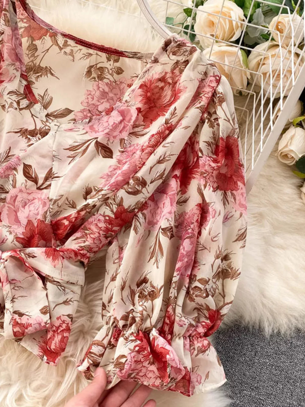 Chic floral crop top with puff sleeves and ruffled cuffs.