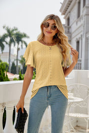 Yellow eyelet flounce sleeve crew neck blouse with intricate patterns.