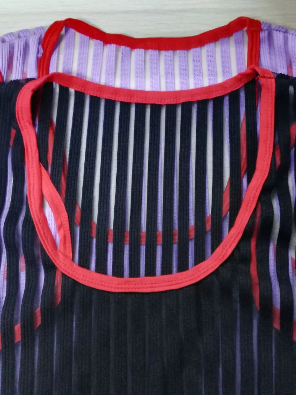 Black sheer stripe tank top with red trim and purple stripe underlayer.