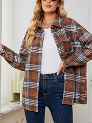 Brown plaid shacket with oversized button detail and chest pocket, worn open over a white top.