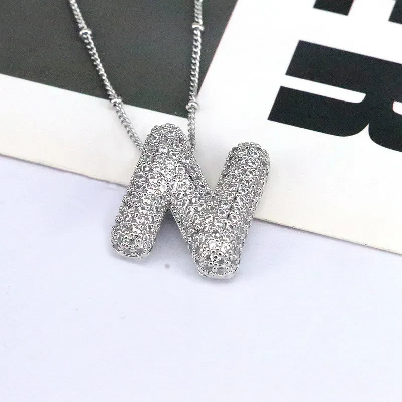 Pave initial pendant necklace with alphabet N charm on a beaded chain.