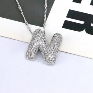 Pave initial pendant necklace with alphabet N charm on a beaded chain.