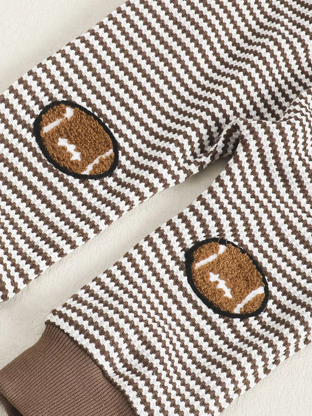 Baby set with brown and white stripes and football elbow patches.