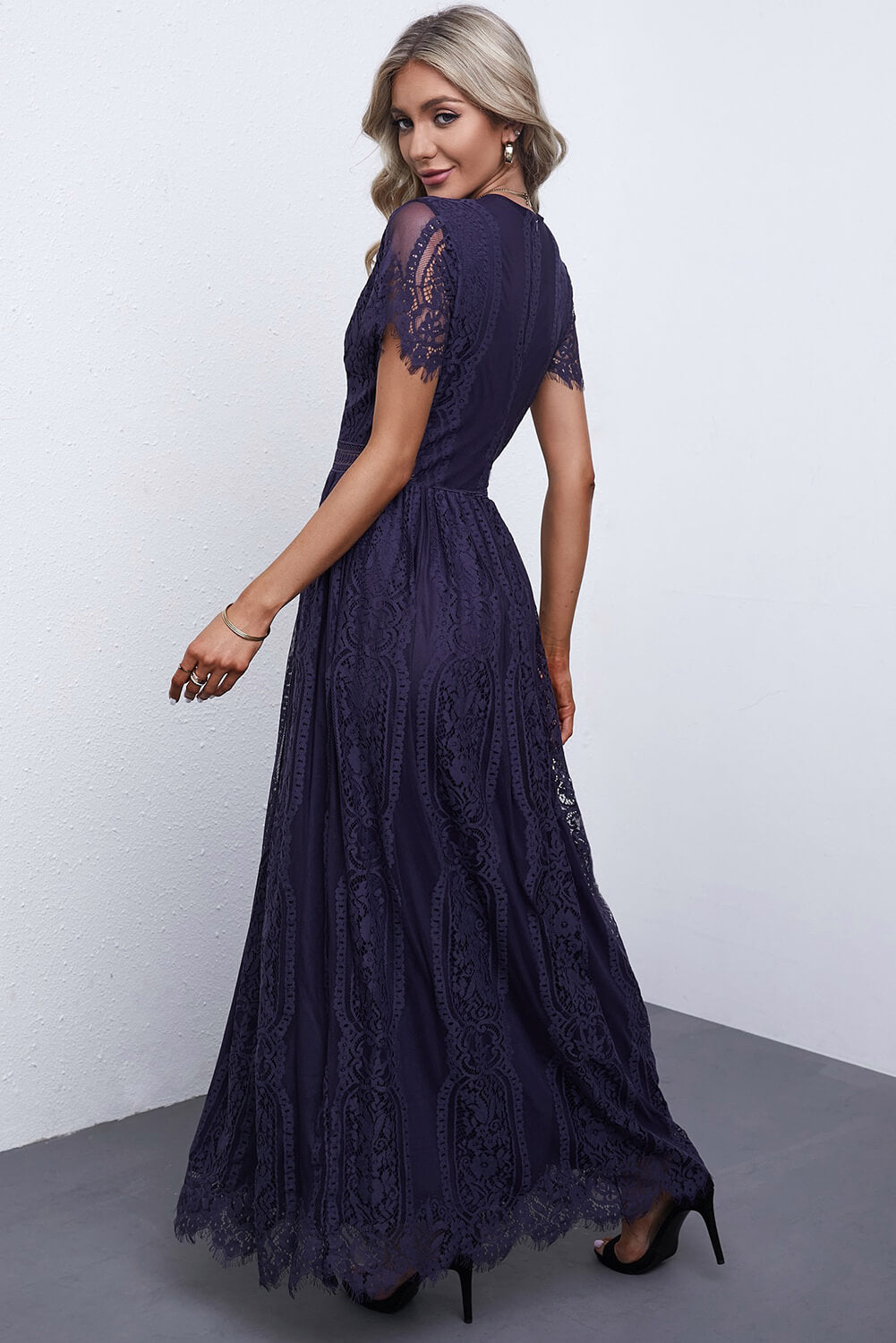 Navy lace midi dress with short sleeves, scalloped hem, and intricate lace overlay.