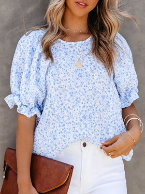 Sky blue floral print maternity blouse with ruffle sleeves and smocked bodice.