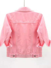 Pink denim trucker jacket with cropped sleeves and rolled cuffs.