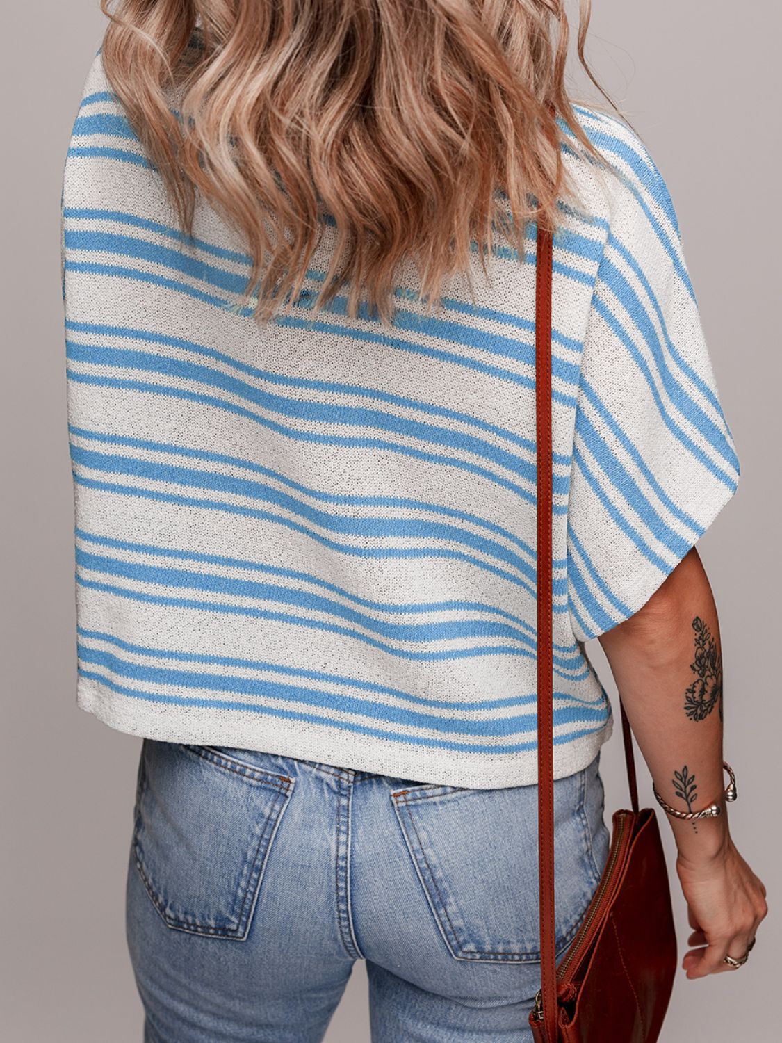 Boxy knit t-shirt in light blue and white stripes with short sleeves.
