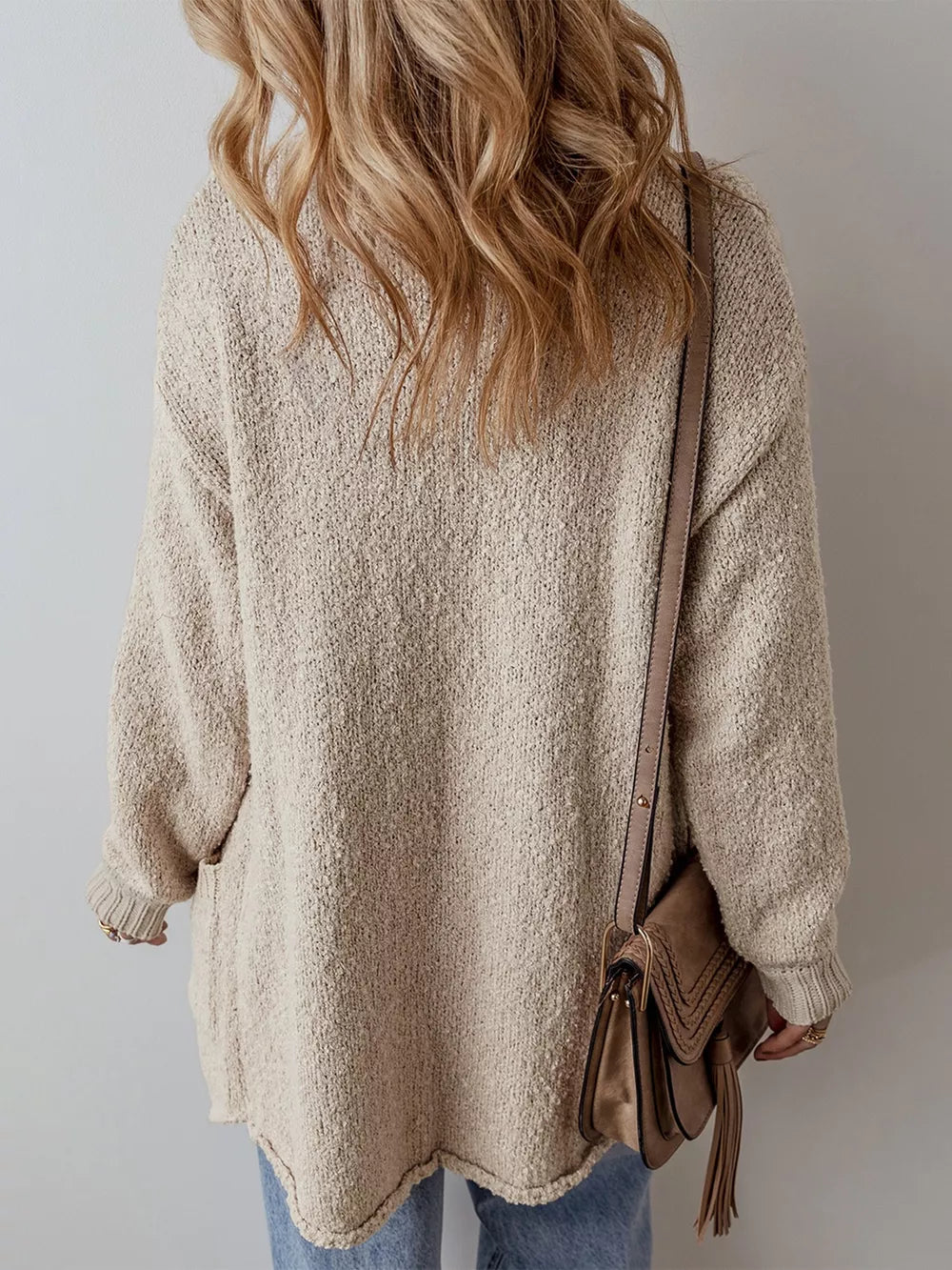 Beige textured button-up maternity cardigan with pockets and cuffed sleeves.