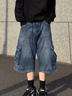 Men's loose fit denim cargo shorts in blue with multiple pockets and drawstring waist.