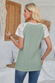 Sage eyelet raglan blouse with white lace short sleeves and scalloped trim.
