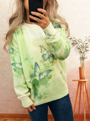 Lightweight knit sweater in green with allover butterfly print and rhinestone details.