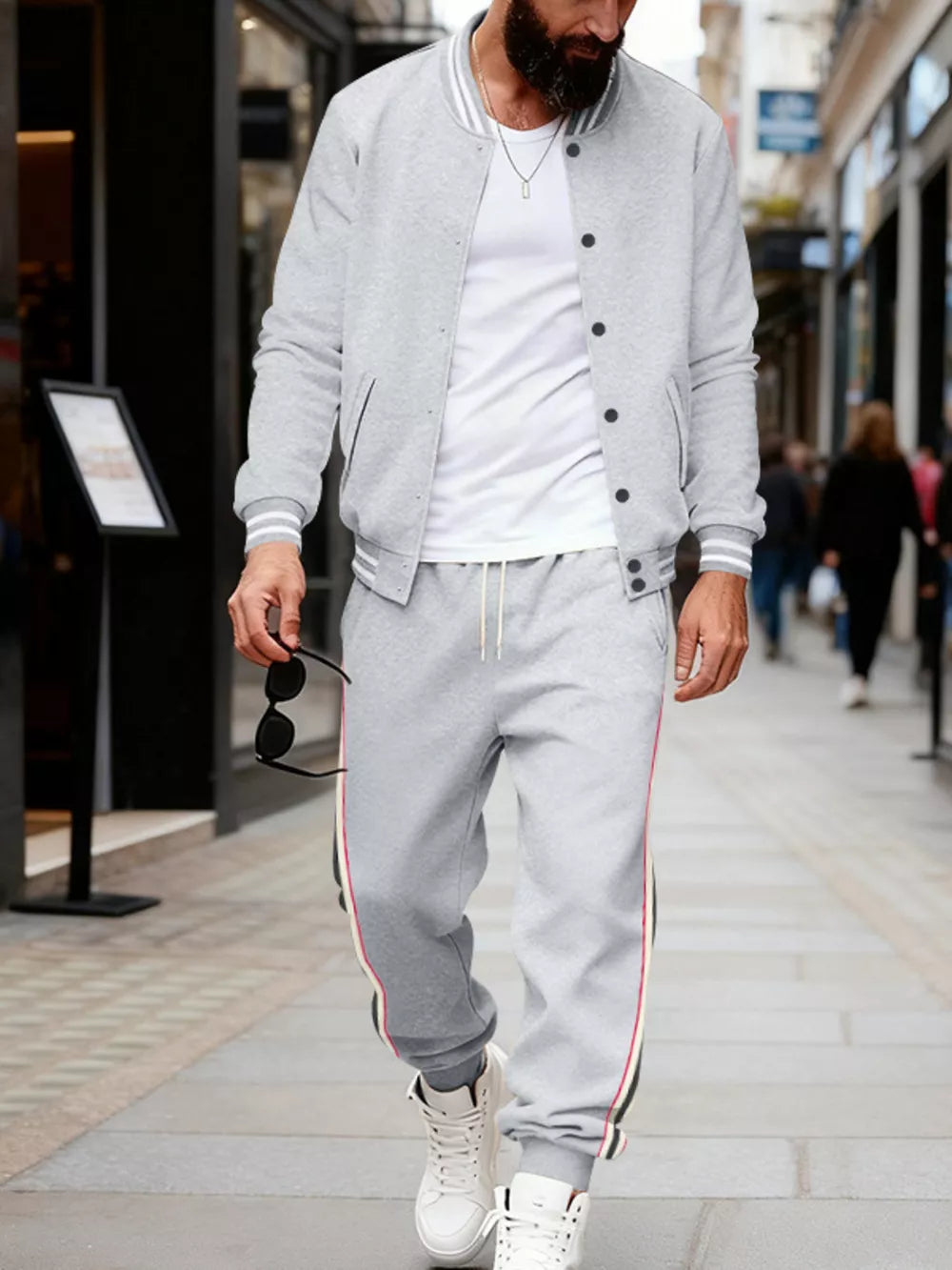 Light gray men's track pants with drawstring and side stripe detail.
