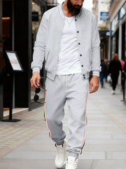 Light gray men's track pants with drawstring and side stripe detail.