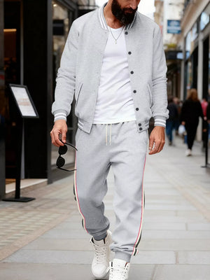 Light gray men's track pants with drawstring and side stripe detail.