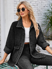 Black denim button-up jacket with cuffed sleeves and chest pockets.