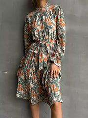 Green floral midi dress with tie waist and pleated skirt