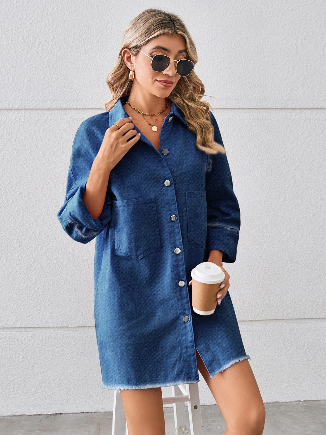 Dark blue denim shirt dress with raw hem, button front, and chest pockets.