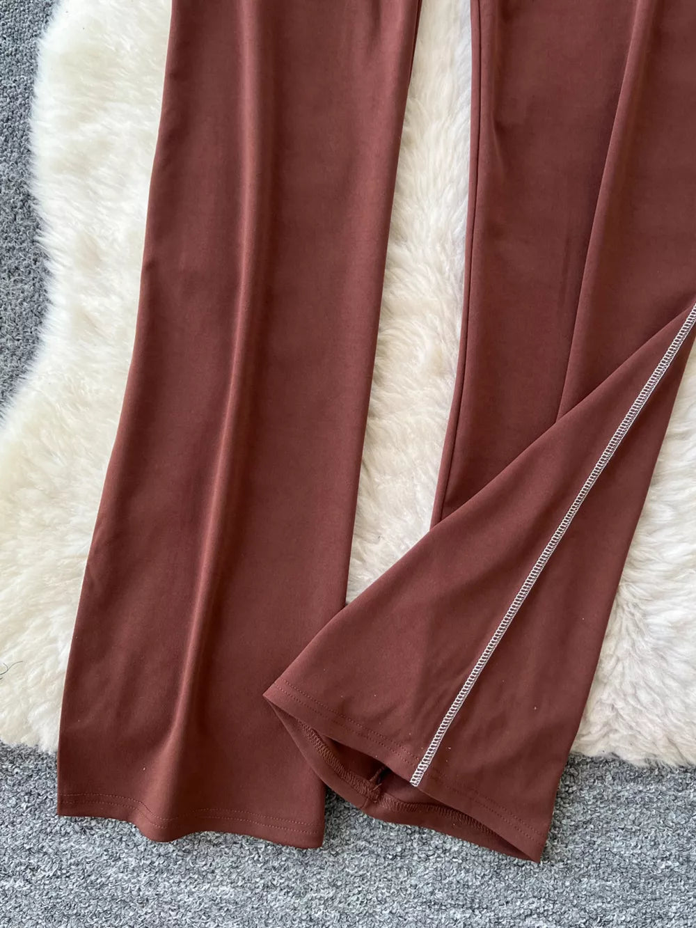 Brown maternity pants with wide legs and contrast stitching detail on the hem.