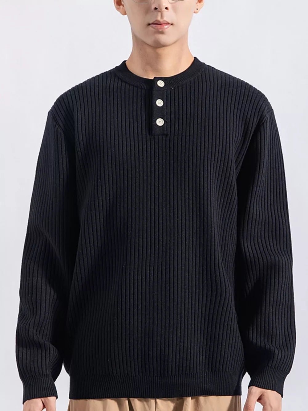Men's black ribbed knit top with three button details at the neckline.