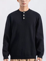 Men's black ribbed knit top with three button details at the neckline.