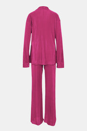 Fuchsia pink pleated shirt and wide-leg trouser set with collared neckline and long sleeves.