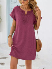Deep purple V-neck dress with lace trim and cuffed short sleeves.