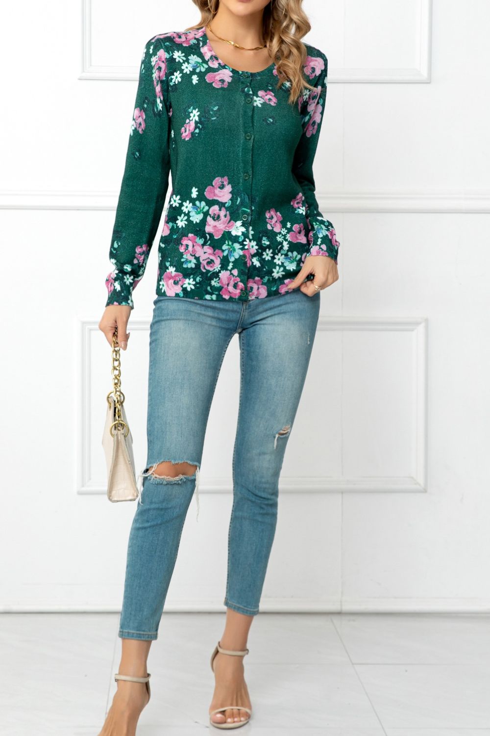 Forest green crewneck cardigan with pink floral print, button front, long sleeves.