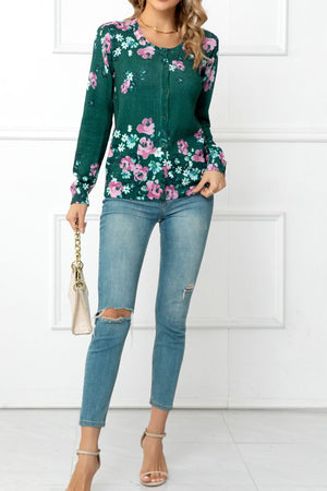 Forest green crewneck cardigan with pink floral print, button front, long sleeves.
