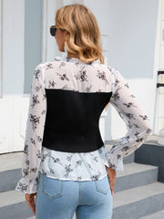 Black and white floral print blouse with a black ribbed bodice overlay.