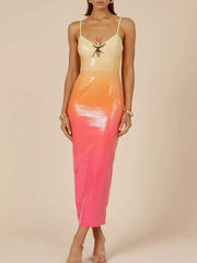 Sequined cami dress with gradient apricot to pink, cutout bust detail, and spaghetti straps.