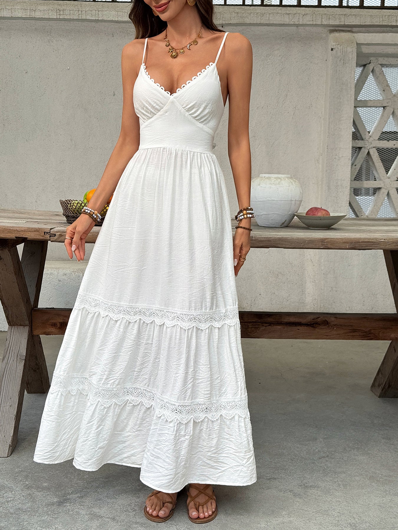 White lace tiered maxi dress with spaghetti straps and scalloped neckline.