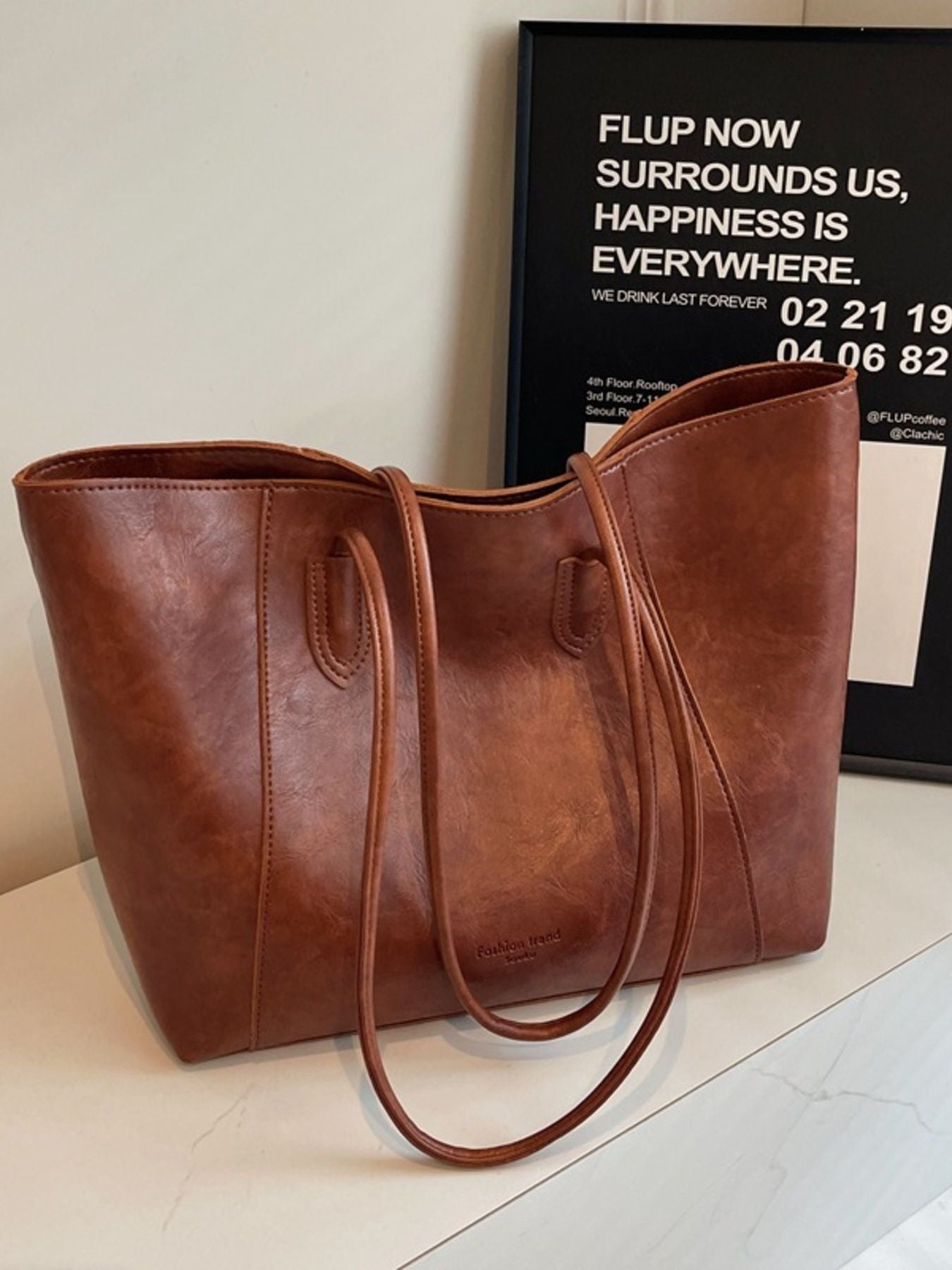 Premium crinkled pu leather tote bag in coffee brown with double shoulder straps and a spacious interior.
