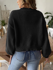 Black bubble sleeve cardigan with pearl buttons and ribbed cuffs.