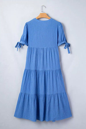 Blue tiered midi dress with notched neckline and tie-sleeve detail