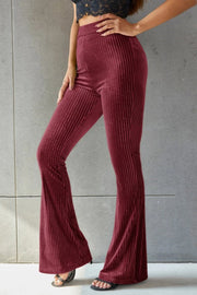 Burgundy ribbed velvet palazzo trousers with a flared leg