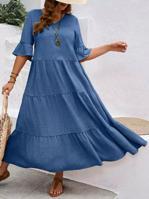 Navy blue tiered midi dress with ruffle sleeves and crinkled texture.