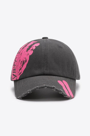 Dark gray baseball cap with distressed brim and pink graffiti art detail.